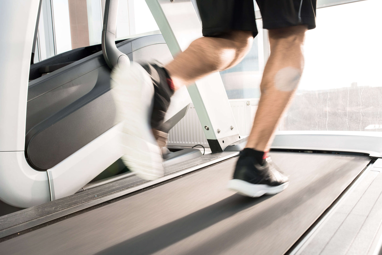 Picture of a man running on a treadmill when he should be watching what he eats, like low carb, gluten free, grain free just nuts granola JuNula