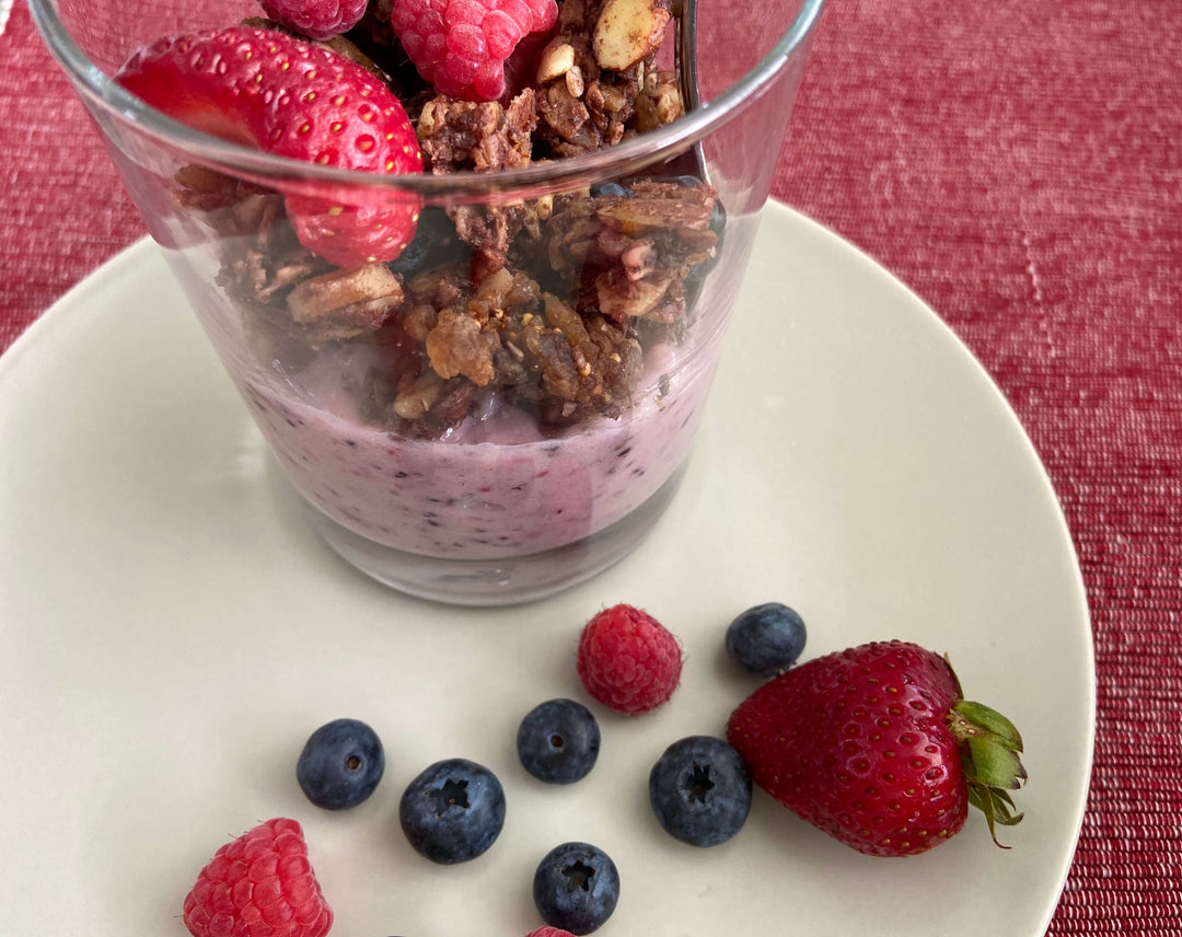 Picture of JuNula just nuts granola in a cup with homemade non-dairy yogurt and fresh strawberries, blueberries and raspberries